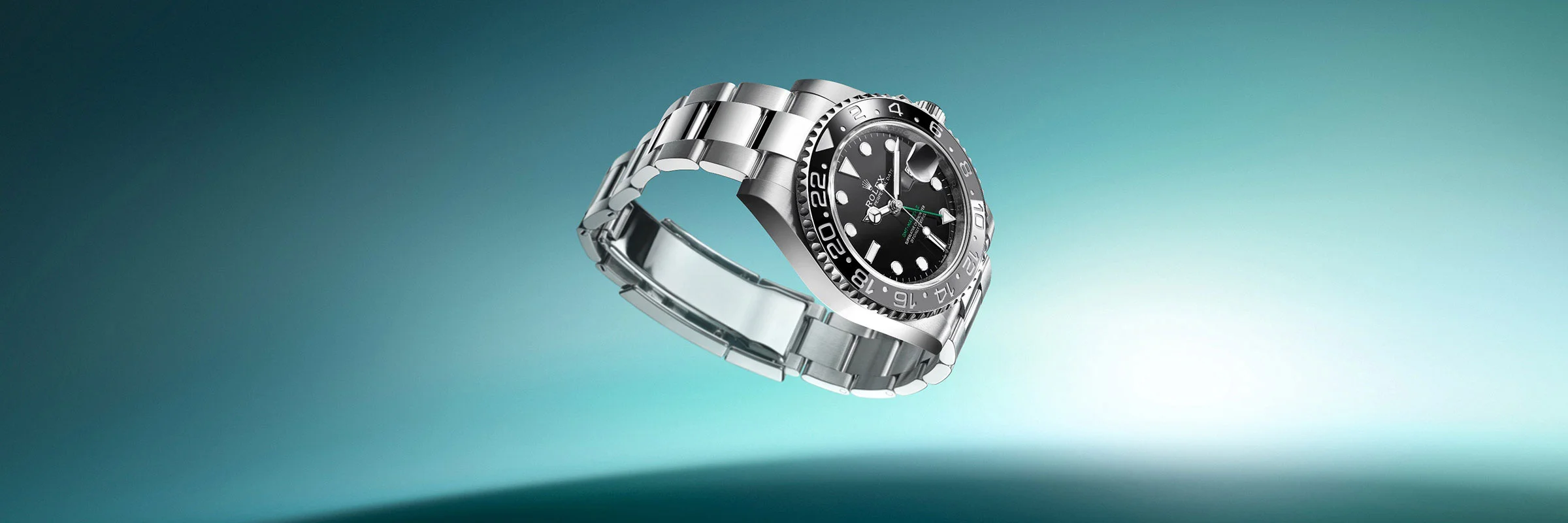 Silver Rolex watch in front of a blue background 